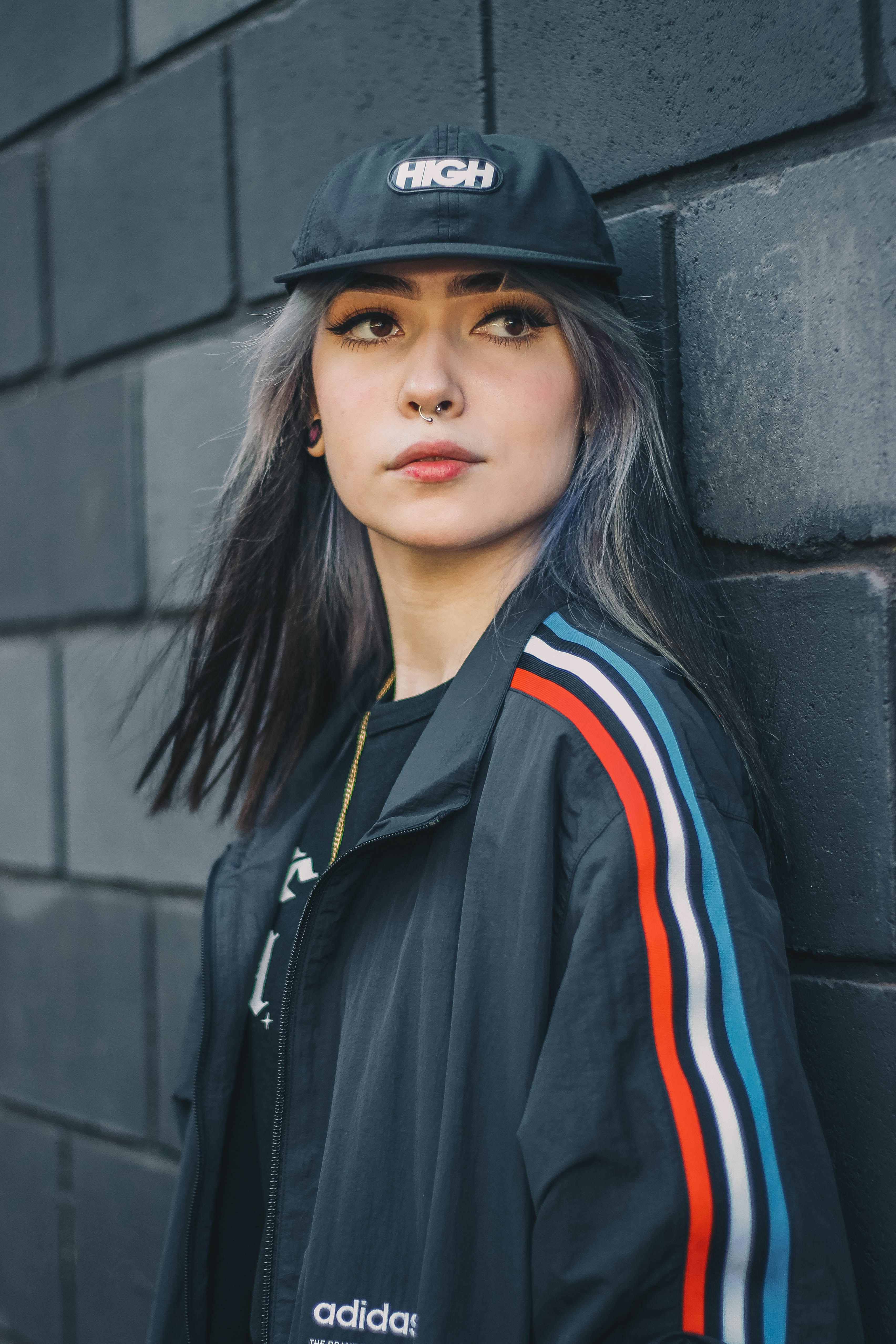 woman in black white and red zip up jacket and black hat